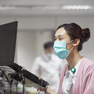 Nurse using laptop while making medical record